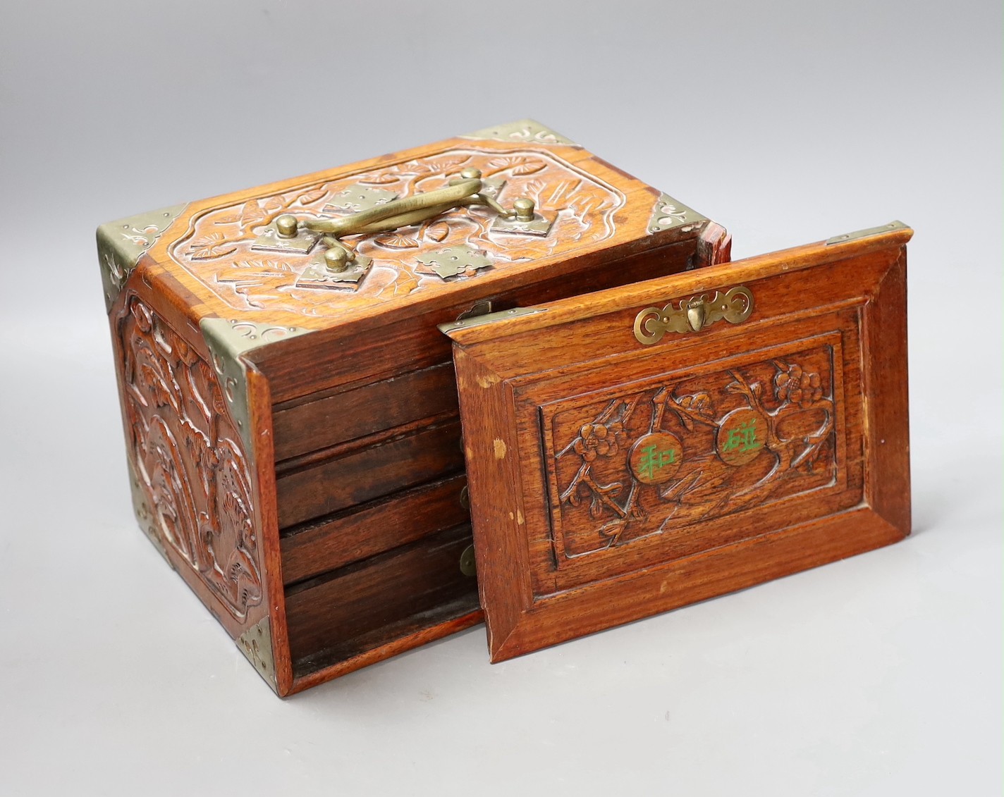 An early 20th century Chinese hardwood cased bone and bamboo mahjong set